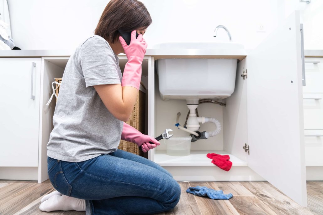 broken and leaking pipe in a woman's bathroom sink